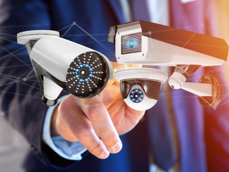 View of a Businessman holding a Security camera system and network connection - 3d rendering
